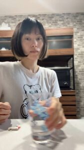 サプリを飲む女性