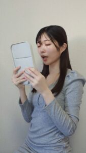 鏡で歯をチェックする女性