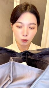 メイクポーチを開けて選ぶ女性｜日常｜メイク｜ファッション