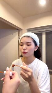 リップを塗りウインクをする女性｜リップ｜メイク｜ウインク